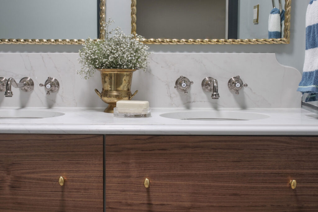 Double Vanity with Scalloped Backsplash and Walnut Cabinetry