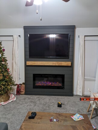 Electric Fireplace with Dark Shiplap Surround and TV