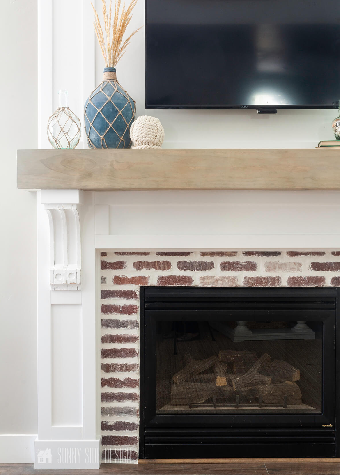 Fireplace Mantel Surround With White Corbels and Brick Veneer