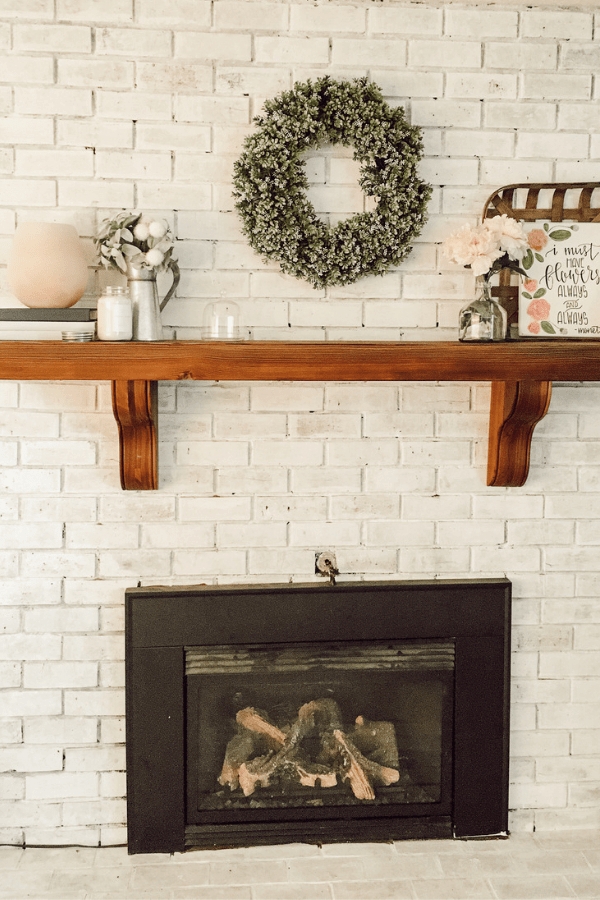 Fireplace Mantel With Decorative Corbels and Whitewashed Brick
