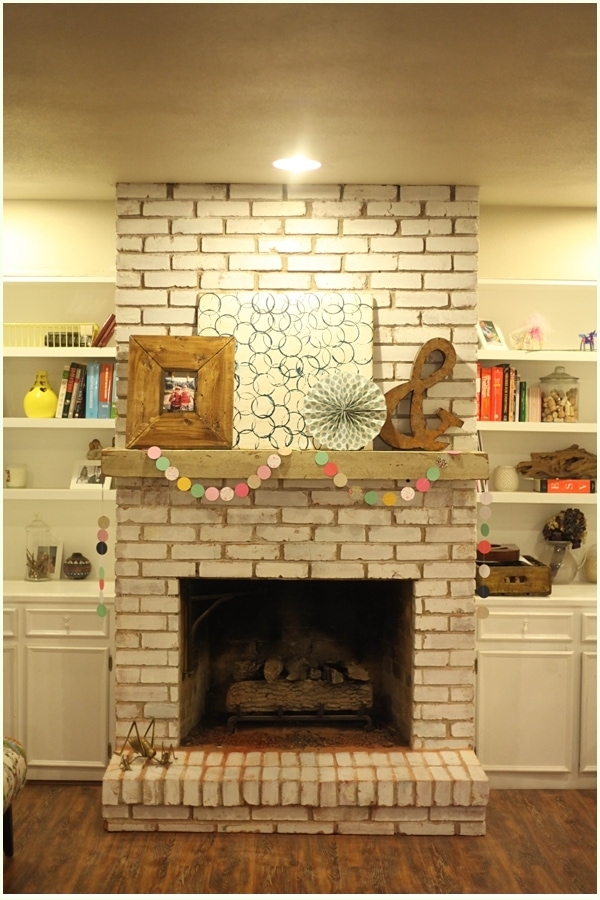 Fireplace Mantle With Whitewashed Brick and Paper Garland