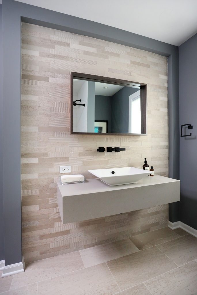 Floating Vanity with Textured Tile Accent Wall and Black Fixtures
