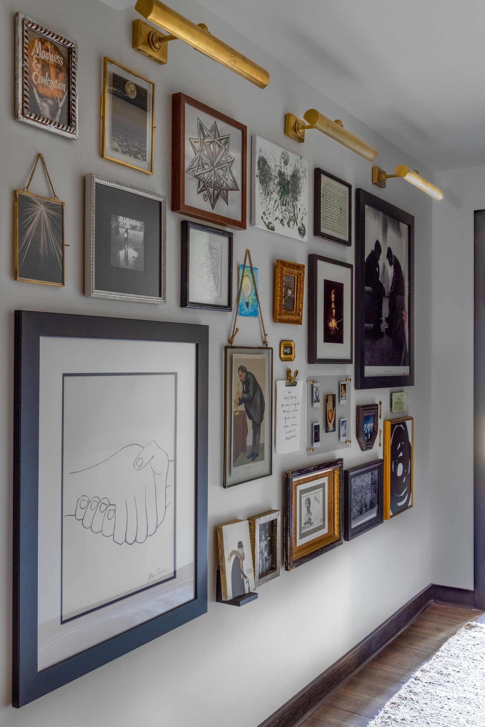 Gallery Wall with Mixed Frame Sizes and Brass Picture Lights Decor