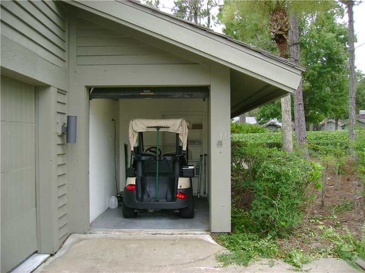 Golf Cart Garage: Sage Green Siding and Compact Shed Roof