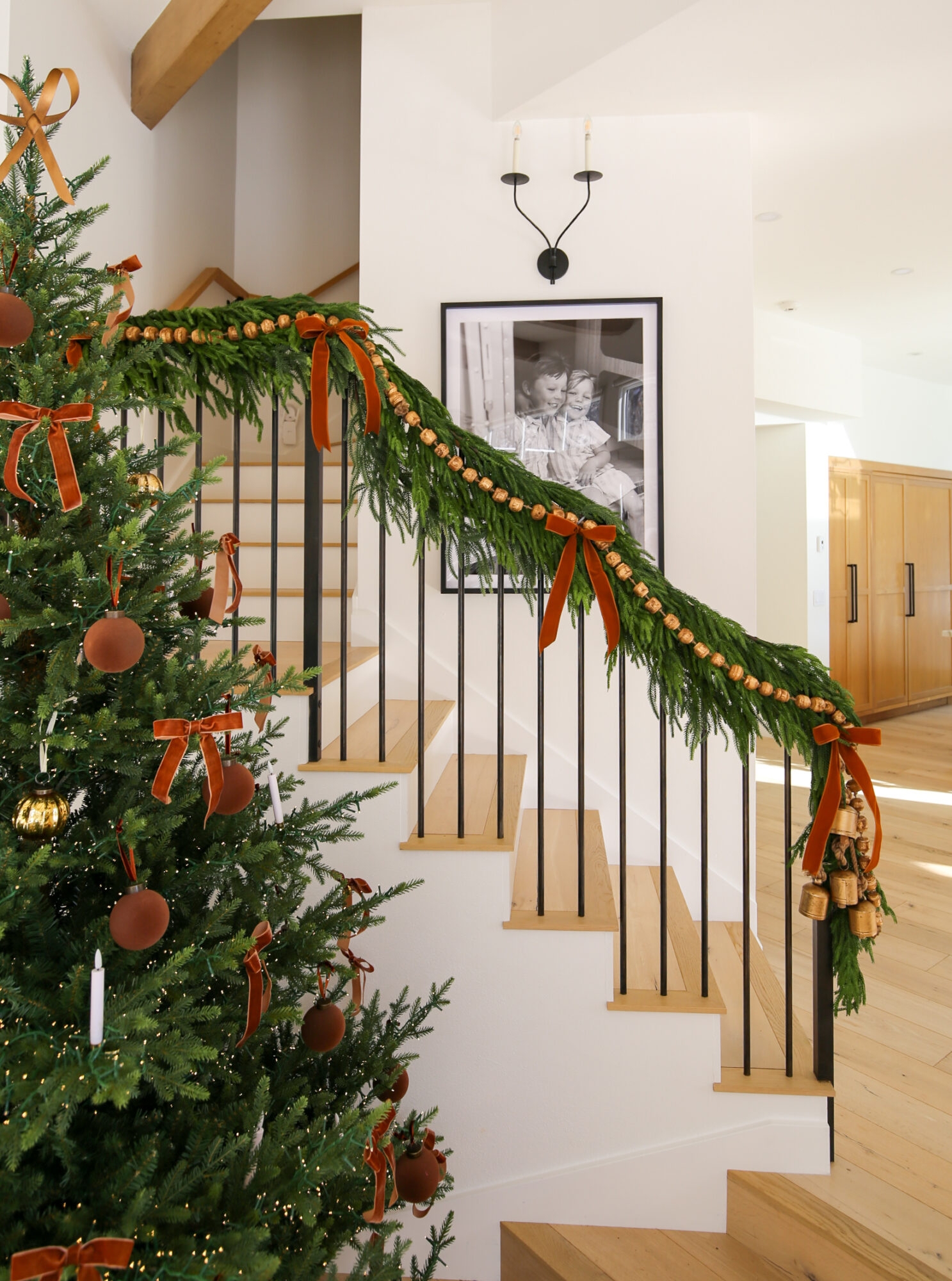 Holiday Staircase with Layered Garland and Rust Velvet Bows