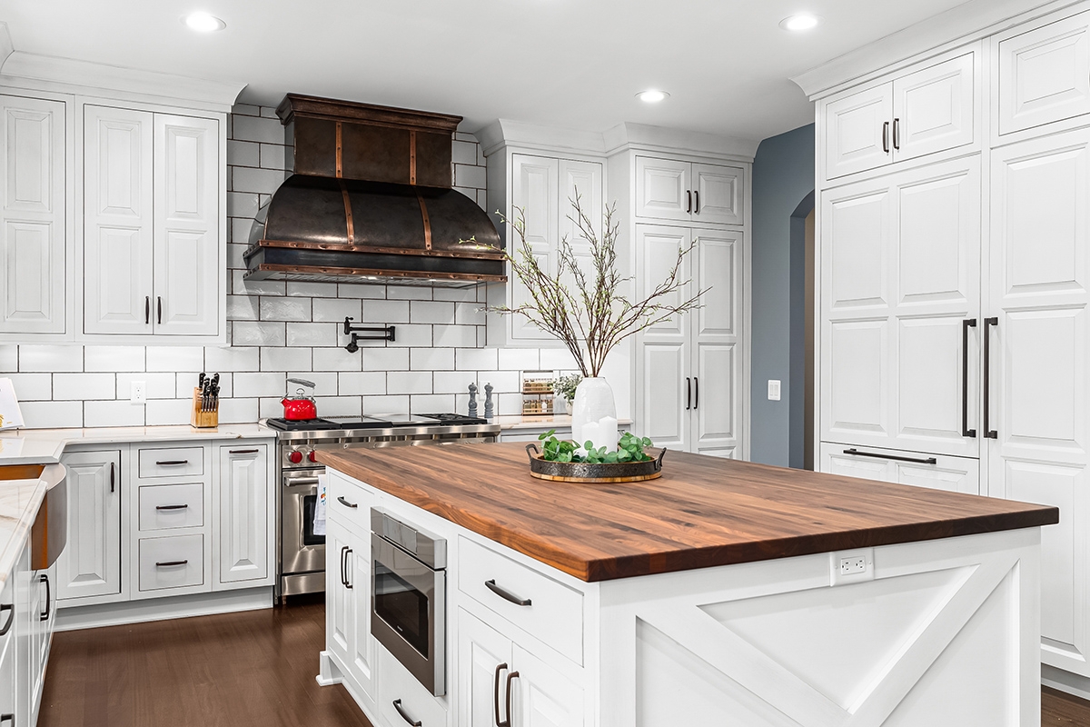 Inset Kitchen Cabinets with Walnut Butcher Block and Metal Hood