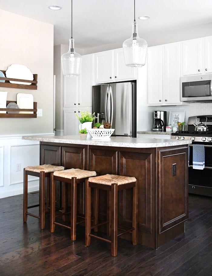 Kitchen Island featuring Raised Paneling and Woven Seat Stools