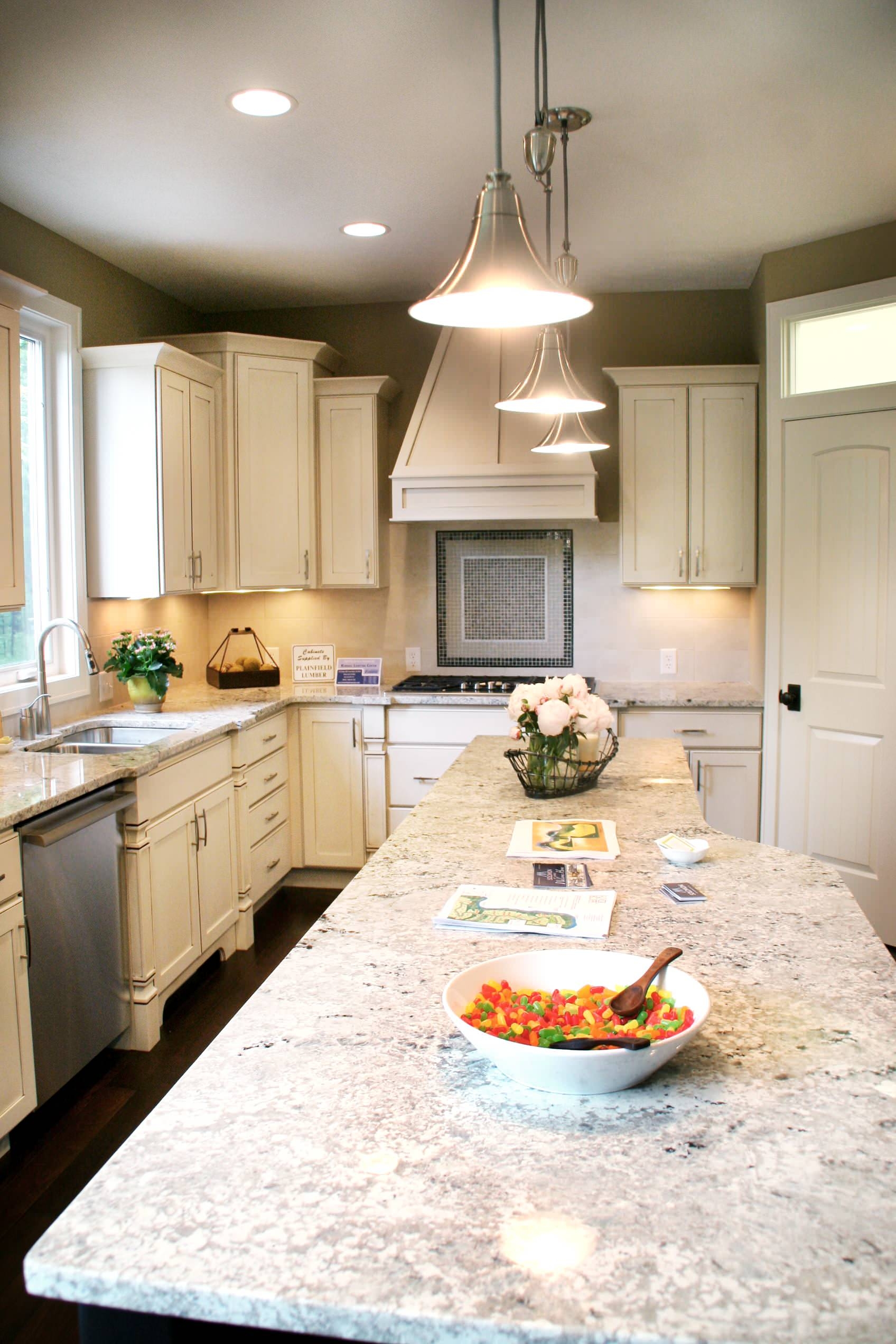 Kitchen Island Speckled Stone Surface Off-White Cabinetry