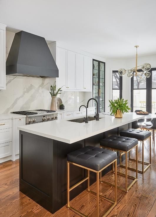 Kitchen Island with Tufted Black Stools and Gold Metal Frames