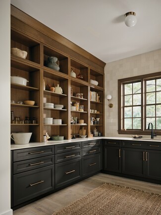 Kitchen Pantry Cabinets with Matte Black Lowers and Slim Brass Pulls