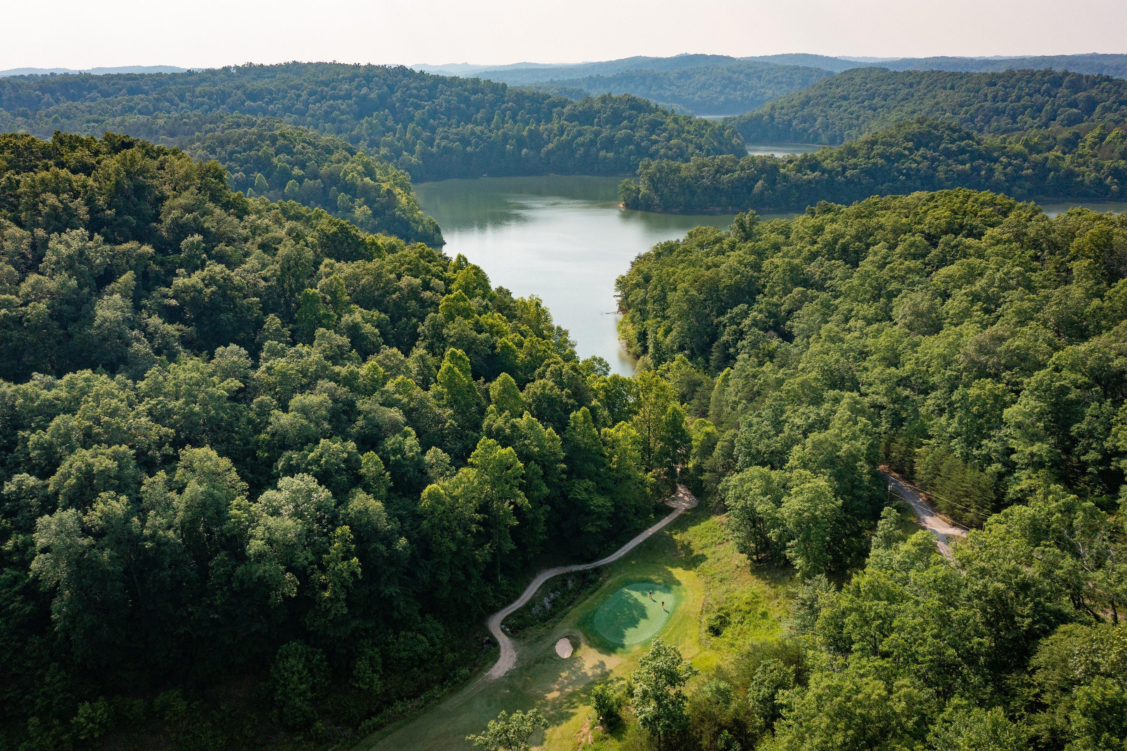 Landscape Aerial Perspective of Forested Rolling Hills and Lake