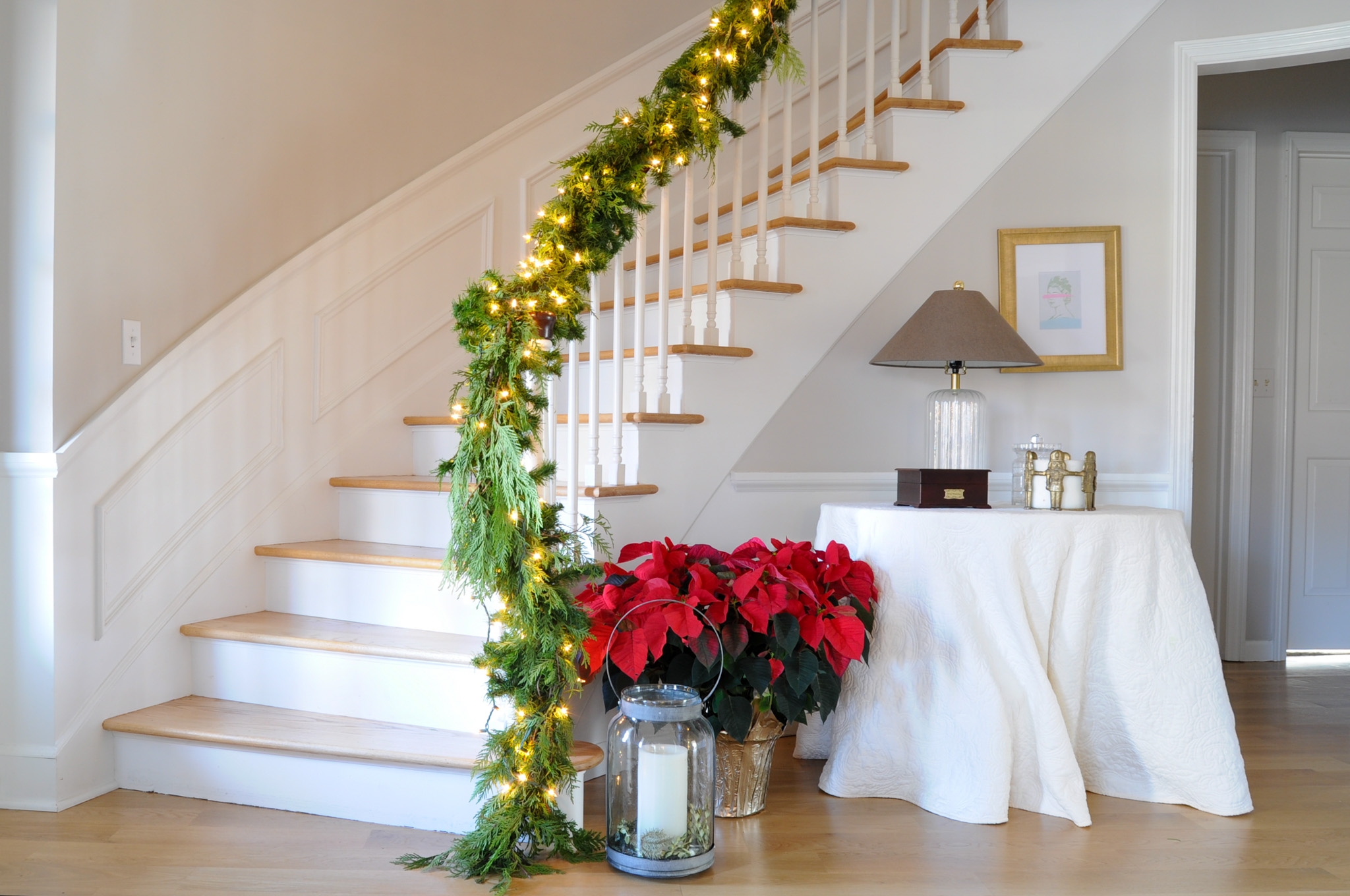 Lighted Staircase Garland with Red Poinsettia Arrangement