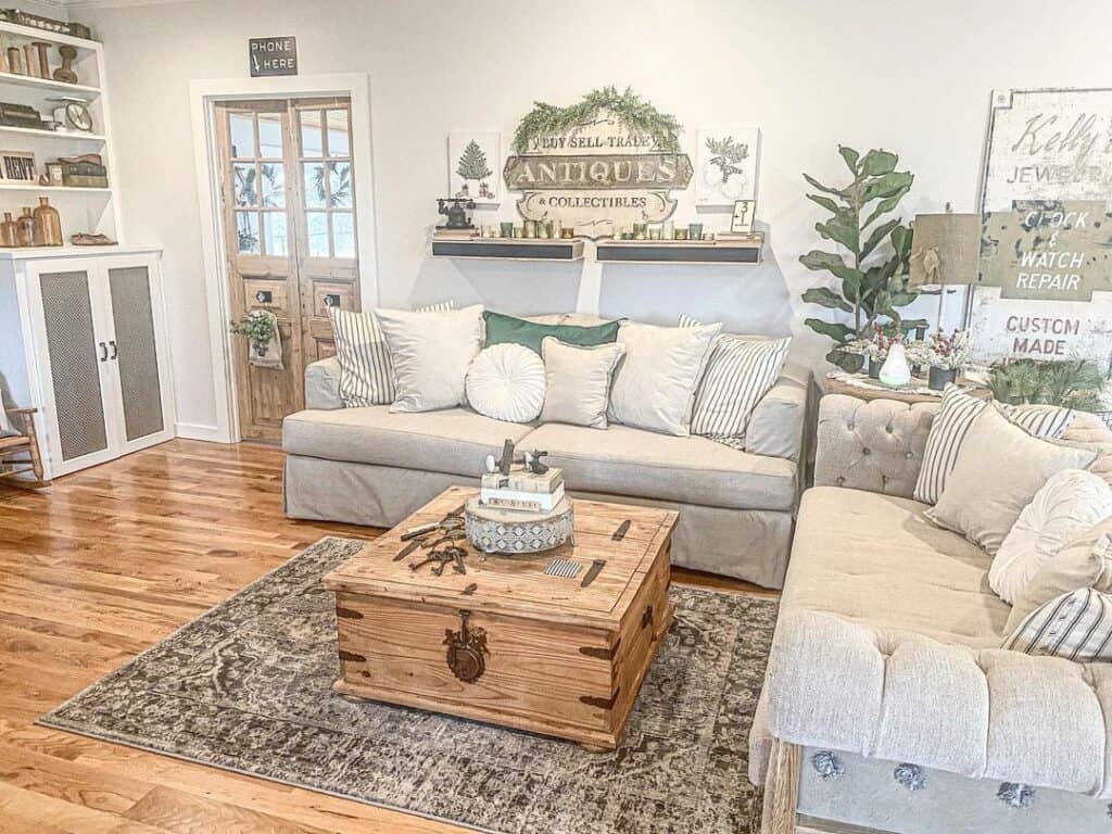 Living Room Set Features Trunk Coffee Table and Antique Wall Signs