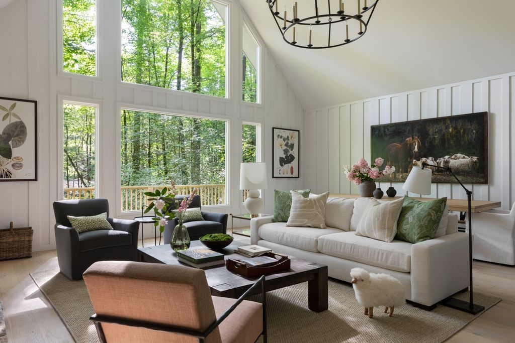 Living Room Set featuring Vertical Paneling and Wooded Forest View