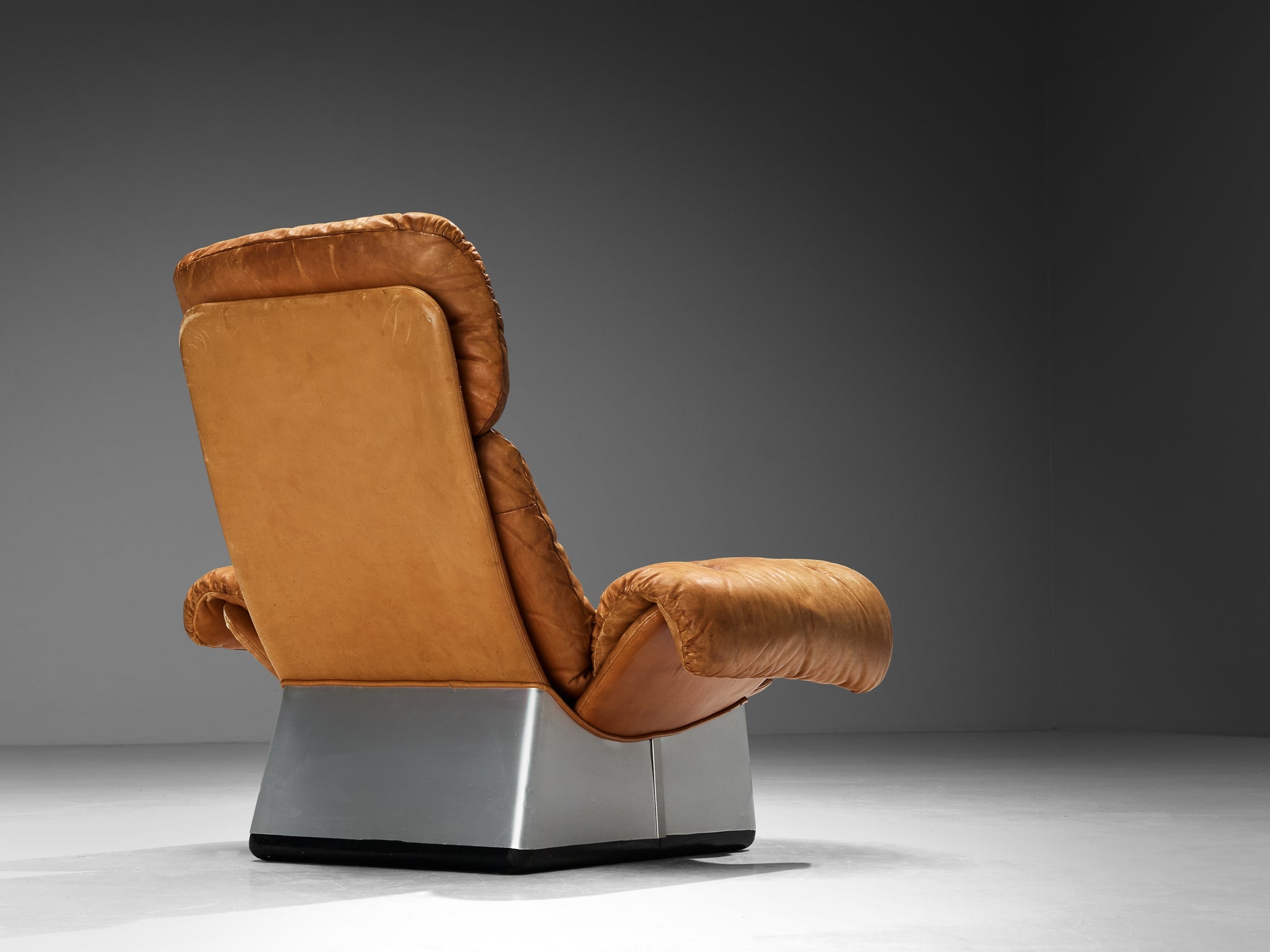 Lounge Chair featuring a Geometric Pedestal Base and Patina