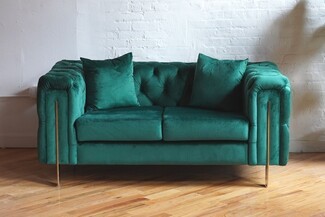 Loveseat with Gold Corner Accents and Tufted Interior