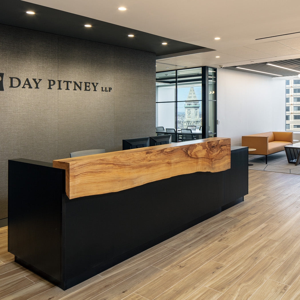 Reception Desk Showcasing Natural Wood Grain and Black Base