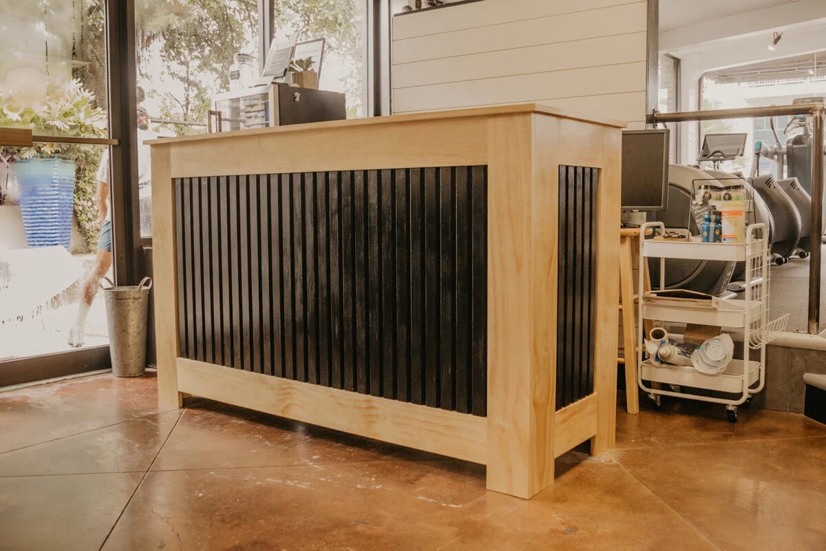 Reception Desk with Contrasting Slat Panels and Black Wood