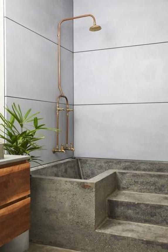 Soaking Tub featuring Concrete Steps and Exposed Copper Shower
