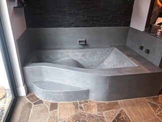 Soaking Tub with Integrated Step and Organic Wave Concrete Basin