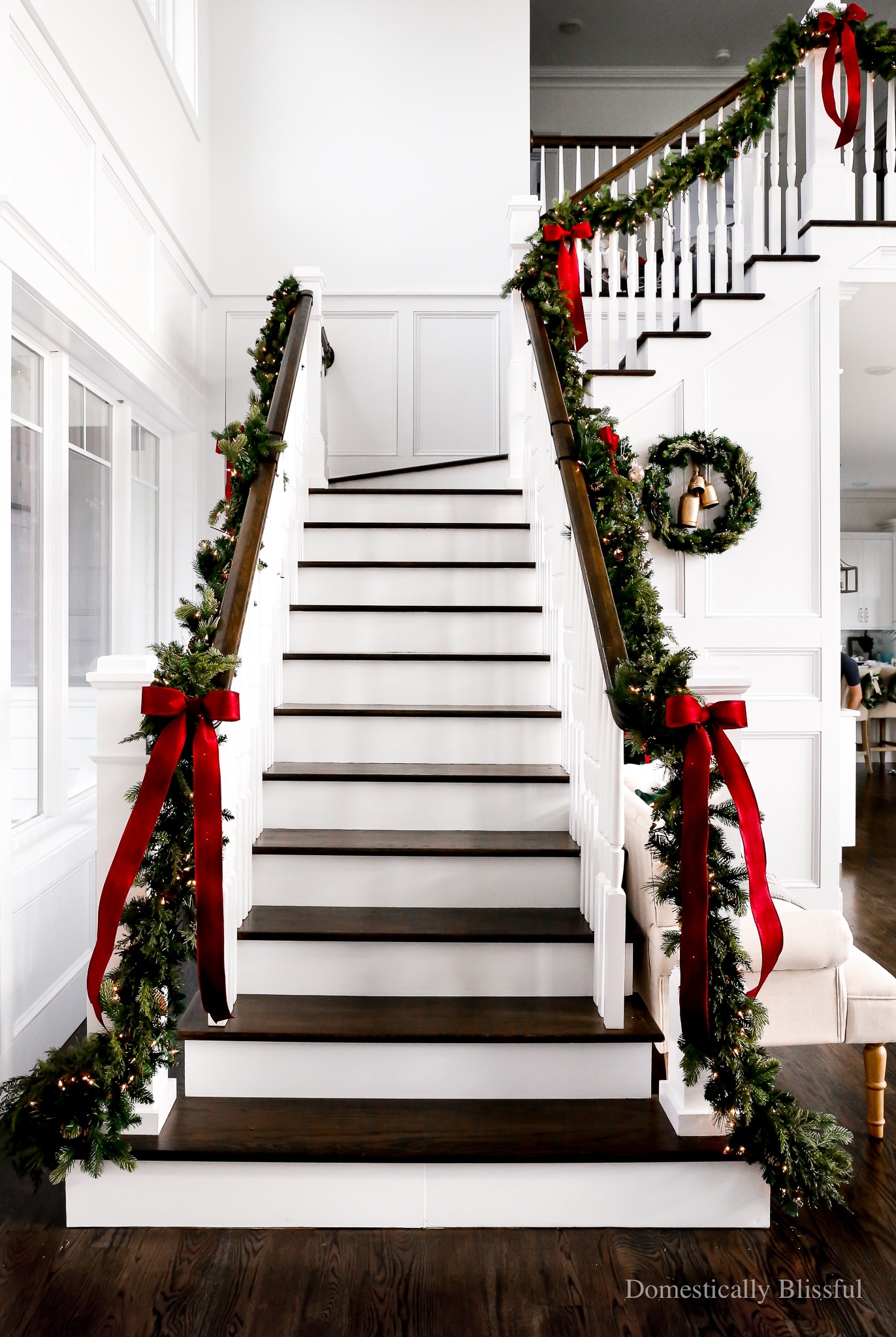 Staircase Garland with Red Velvet Bows and Dark Wood Treads