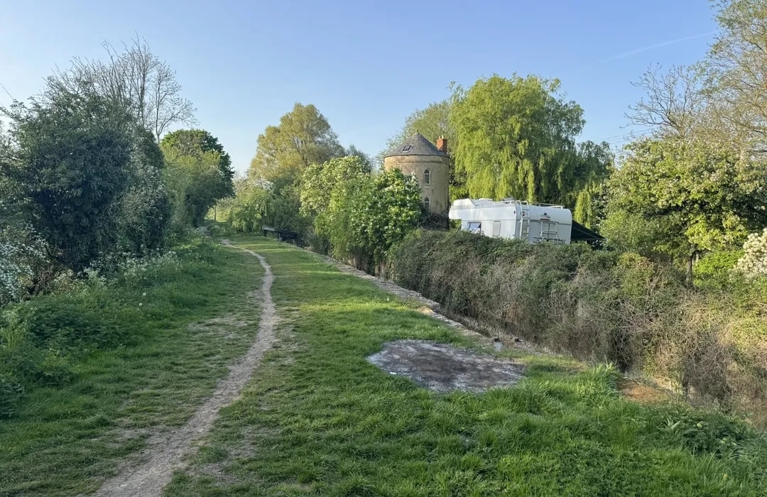 Stone Tower along Winding Path with English Countryside Trail