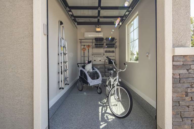 Storage Garage: Glass Paneled Door and Organized Epoxy Floor