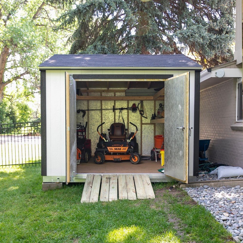 Storage Shed: High-Contrast Lawn Mower Storage with Wood Ramp