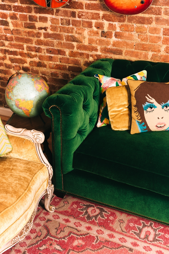 Tufted Sofa with Exposed Brick for a Maximalist Look