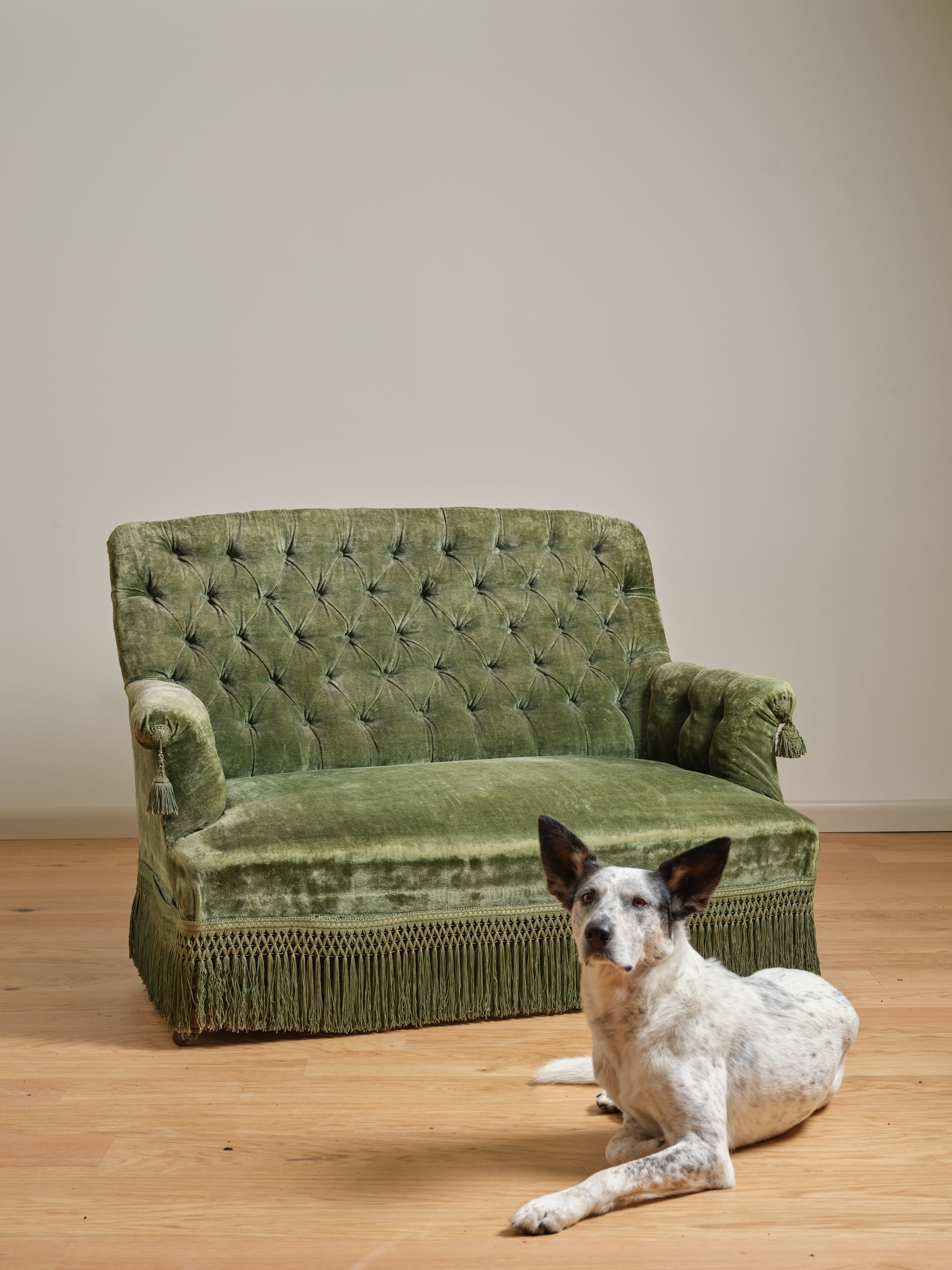 Velvet Settee with Arm Tassels and tufted green loveseat