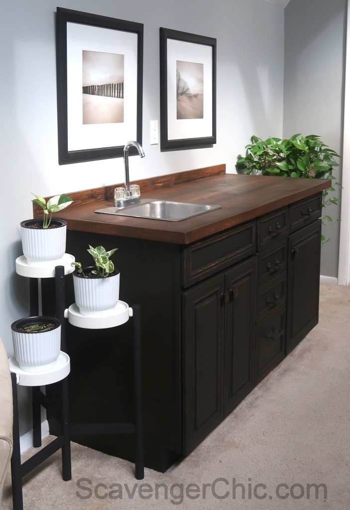 Wet Bar Using Matte Black Cabinetry And Distressed Wood