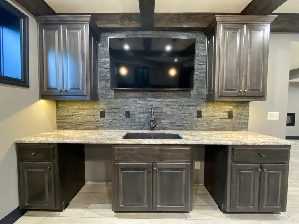 Wet Bar With Stacked Stone Backsplash And Ceiling Beams