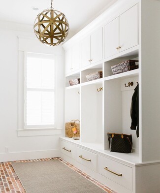 Built In Mudroom with Brick Flooring and Orb Pendant Light