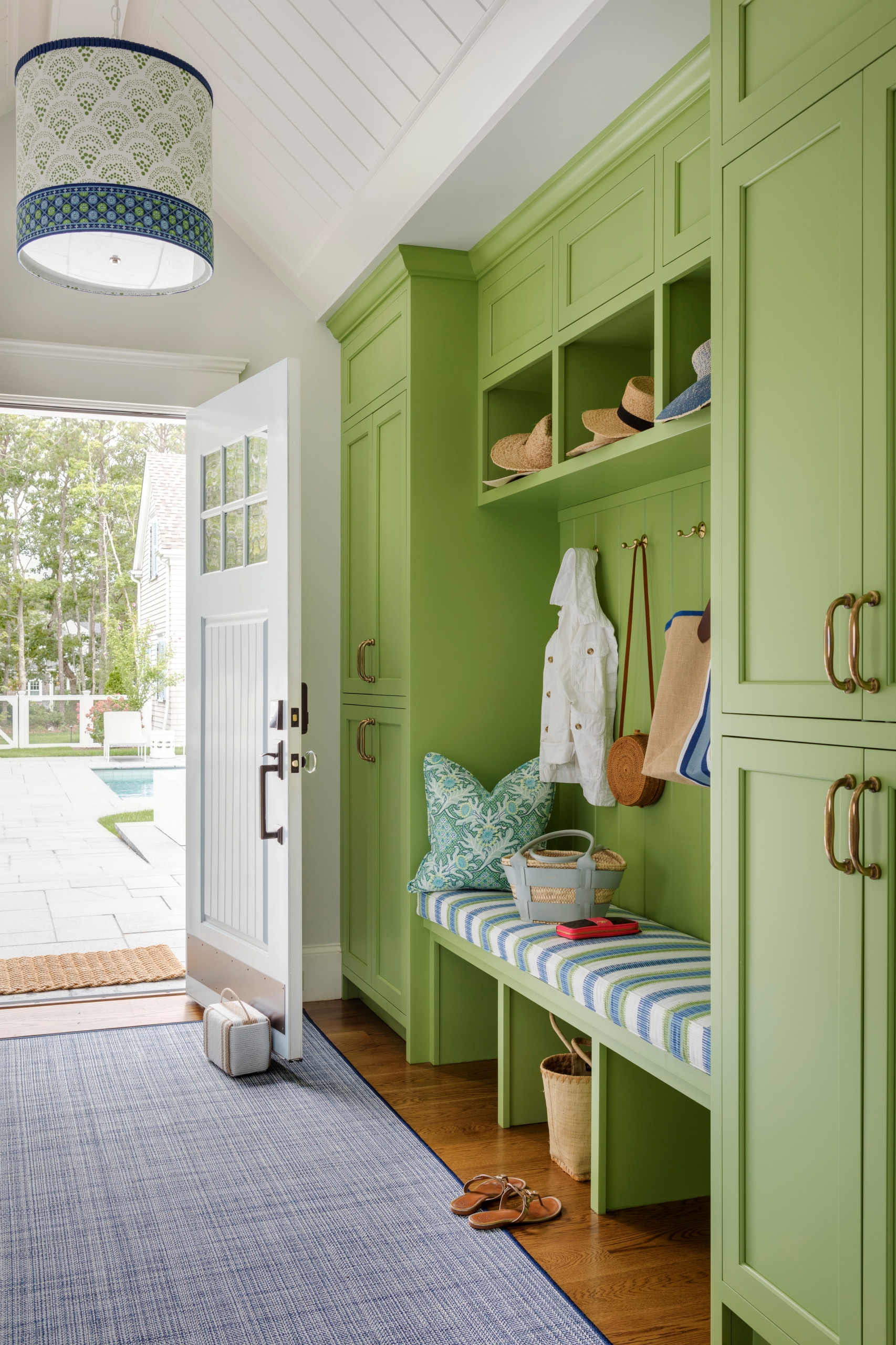 Built In Mudroom with Vibrant Green and Striped Cushions