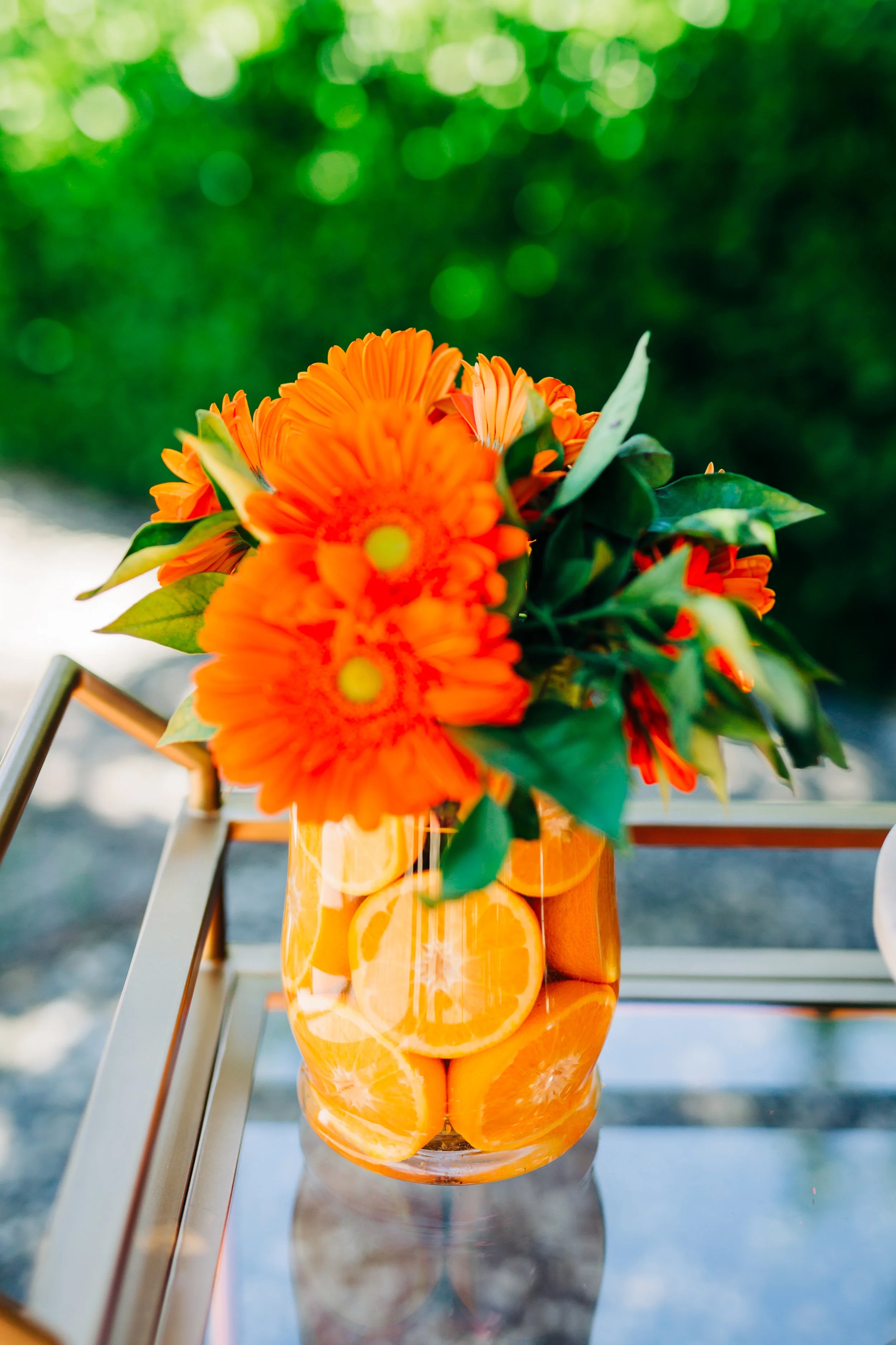 Centerpiece with Citrus Lined Vase and Orange Gerbera Daisies