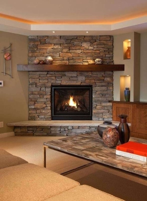 Corner Fireplace With Stacked Stone Facade And Built-In Niches