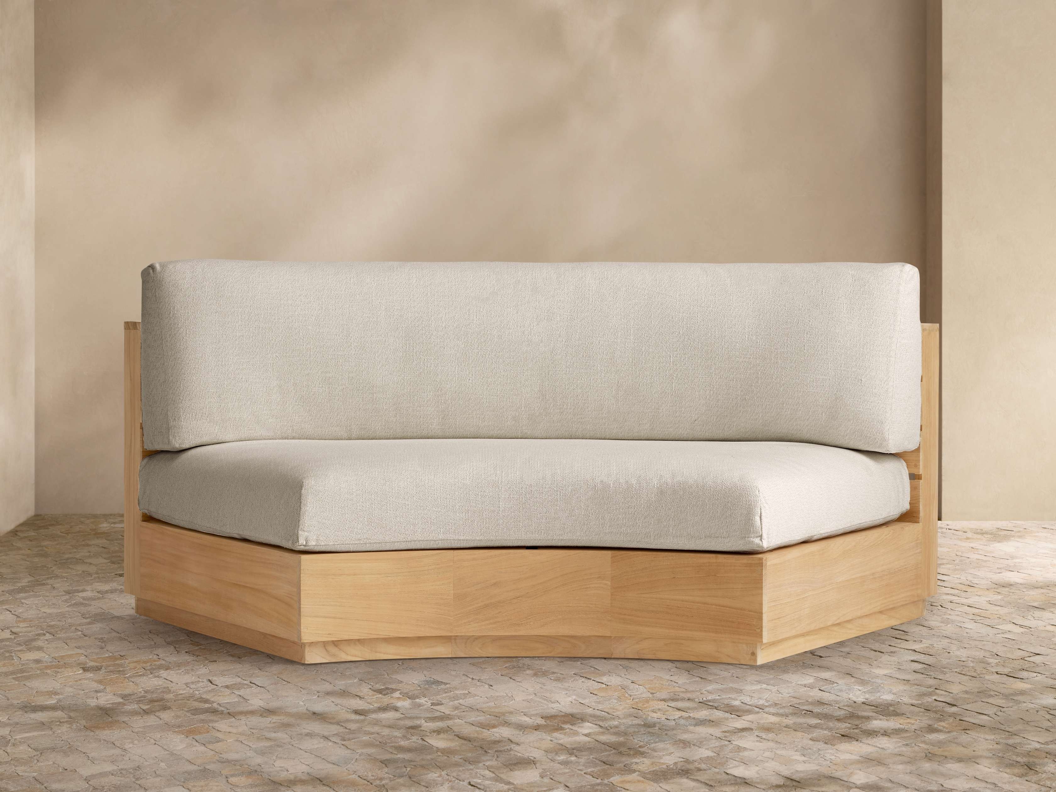 Curved Sofa with Faceted Wood Base and Organic Modern Lines