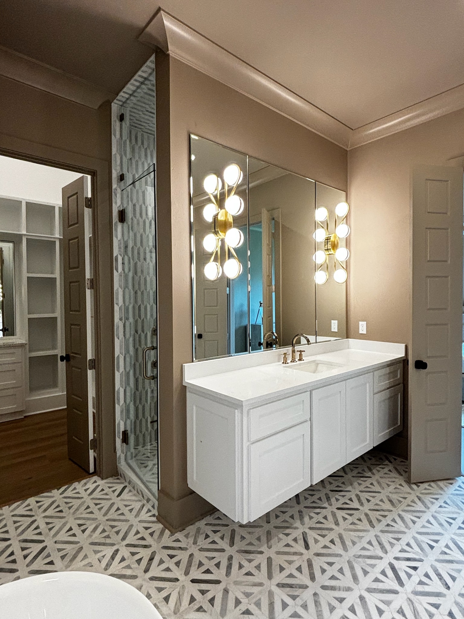 Floating Vanity: Sconce Mirror Cutouts and Geometric Tile