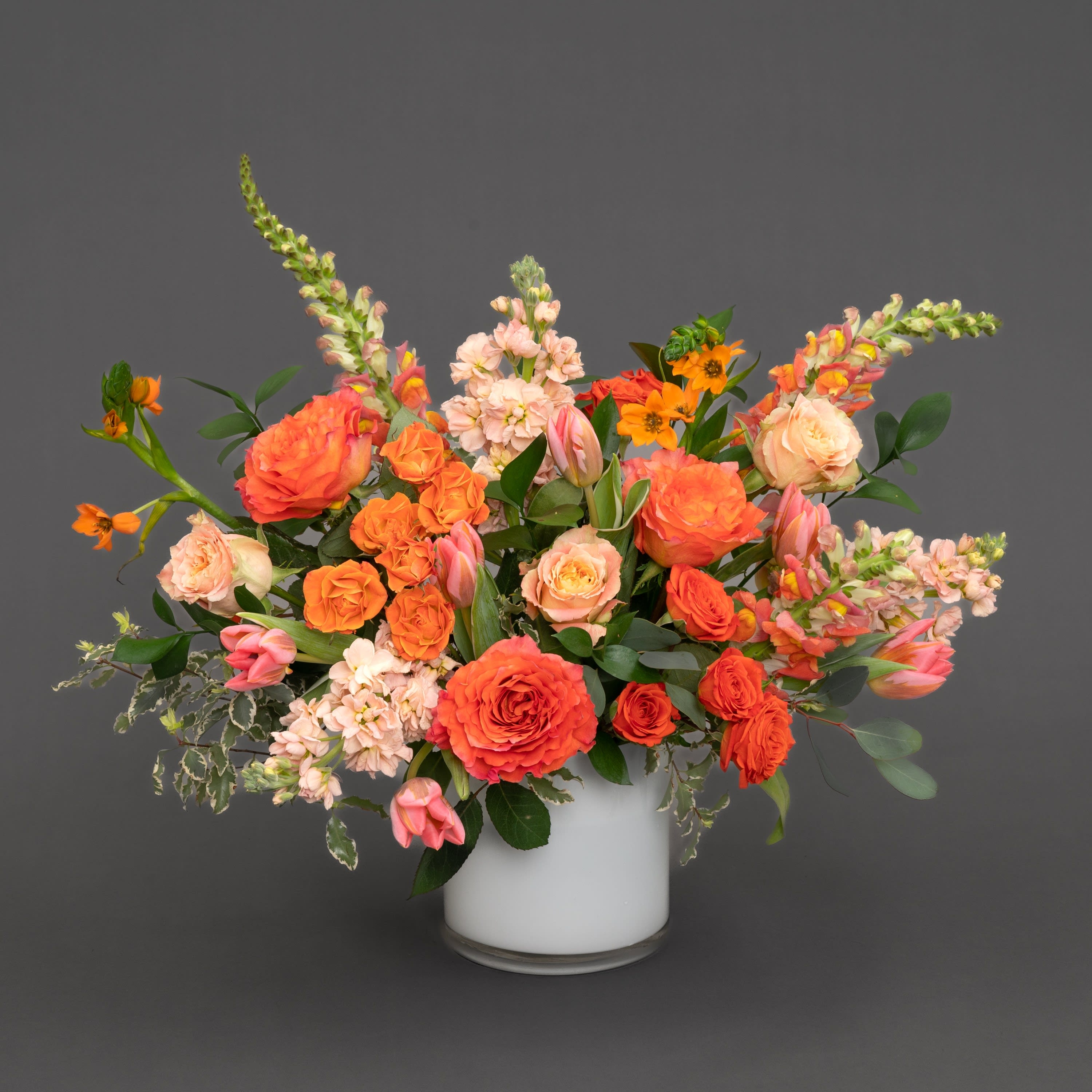 Floral Arrangement in Cylindrical White Vase with Peach Roses