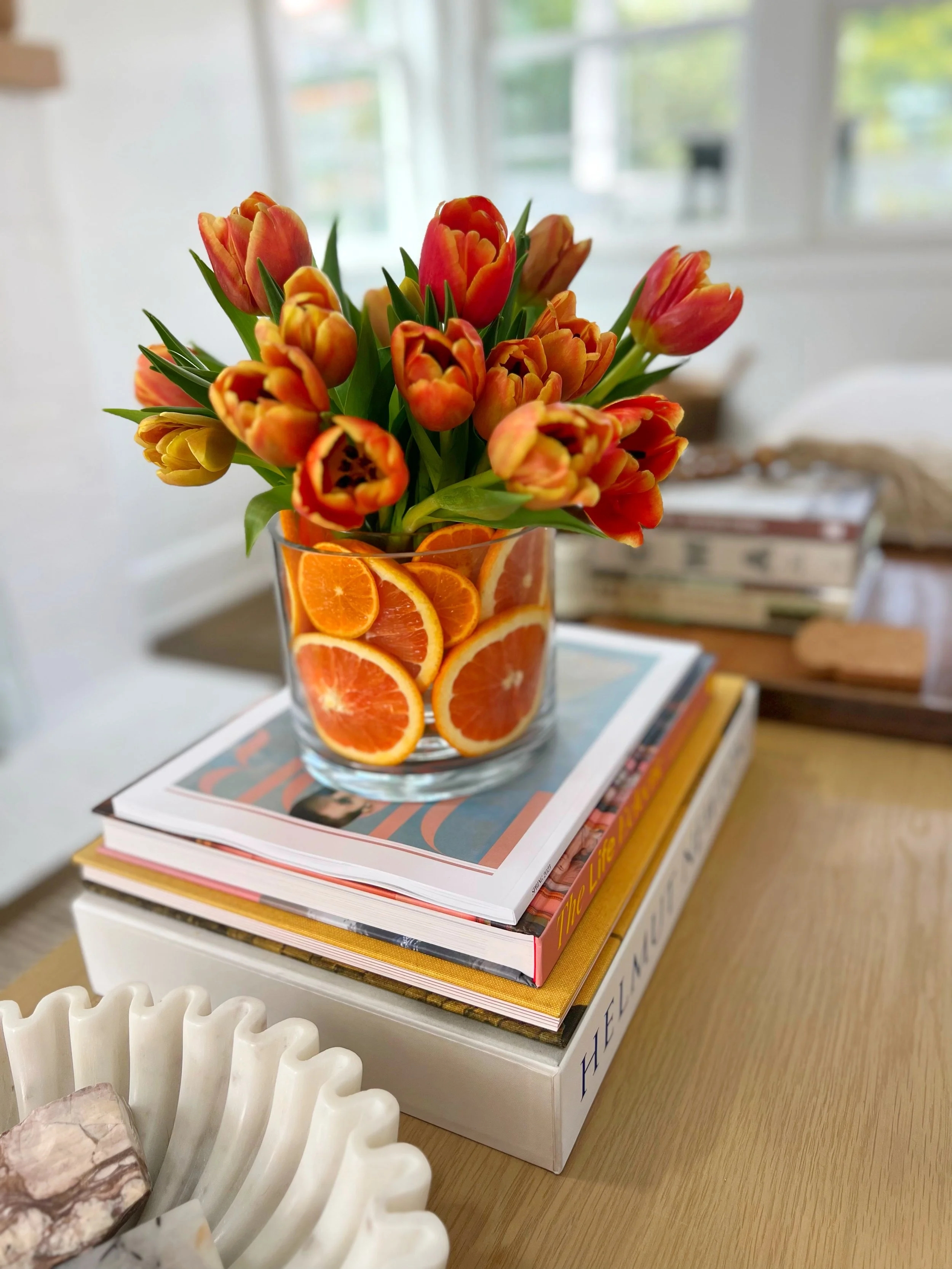 Floral Arrangement on Book Stack Pedestal with Spring Tulips