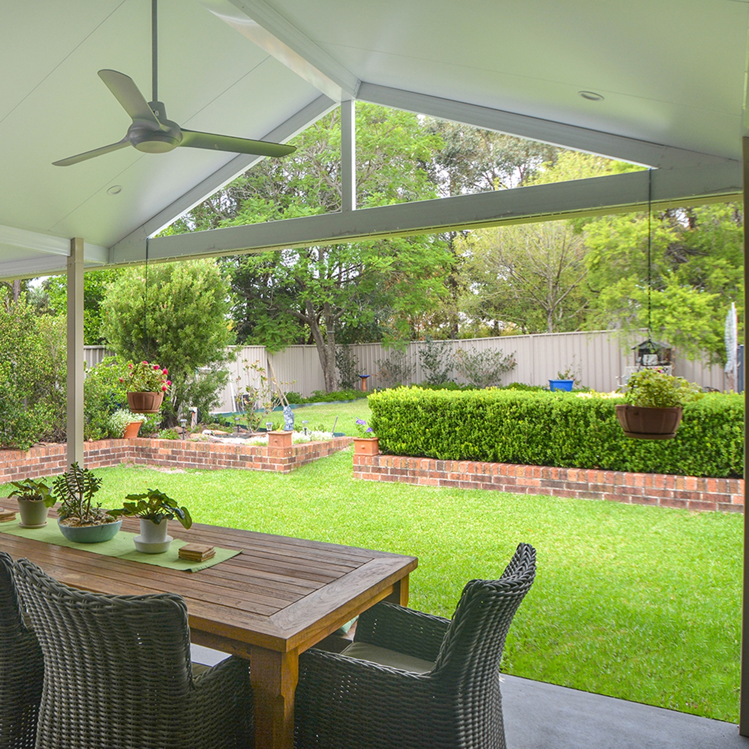 Gable Roof Patio With Vaulted Ceiling and Wicker Dining