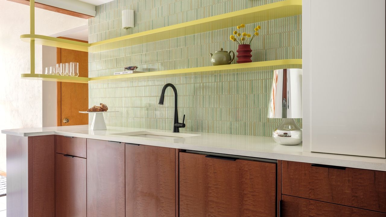 Kitchen Cabinetry Featuring Yellow Floating Shelves and Sage
