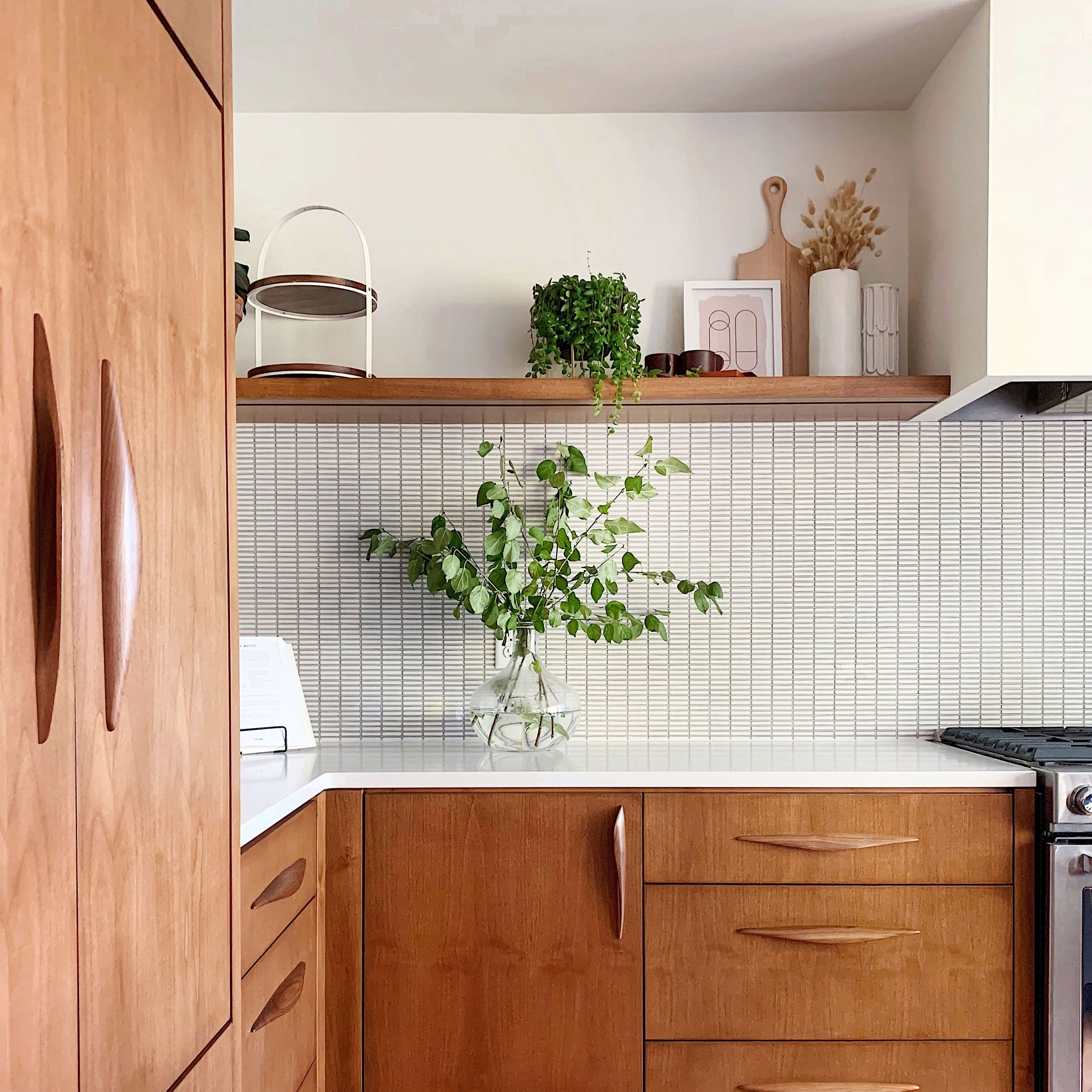Kitchen Cabinetry With Sculptural Wood Pulls and Finger Tile