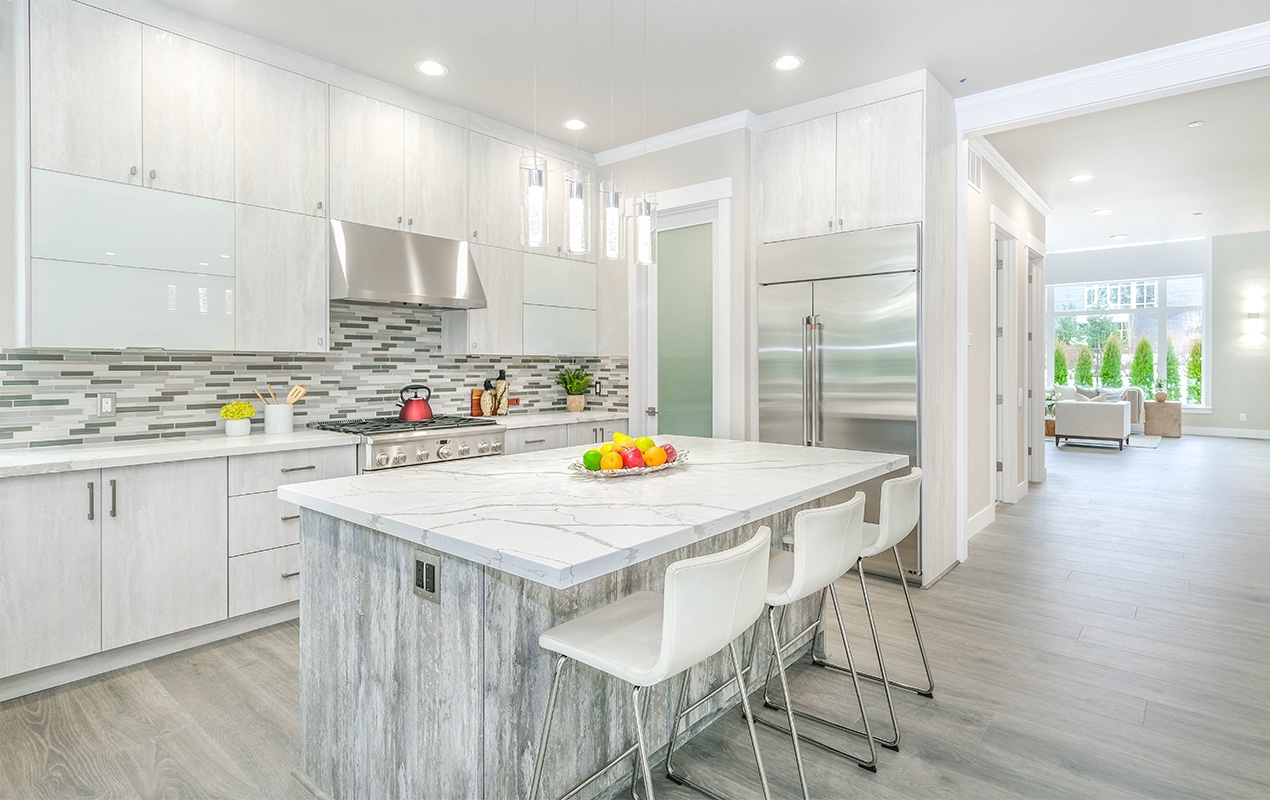 Kitchen Island featuring White Veined Stone and Low Back Stools