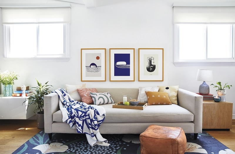 Living Room Set: Triptych Art Above Light Toned Sofa
