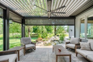 Louvered Pergola Featuring Retractable Screens and Fan