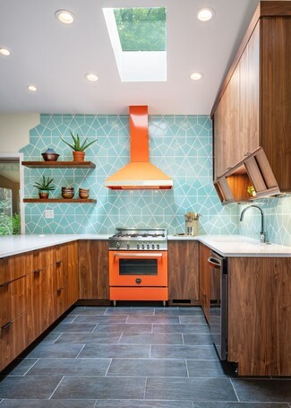 Modern Kitchen Featuring Orange Gas Range Design and Aqua