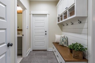 Mudroom Built In with Grey Stained Wood and Gold Hardware