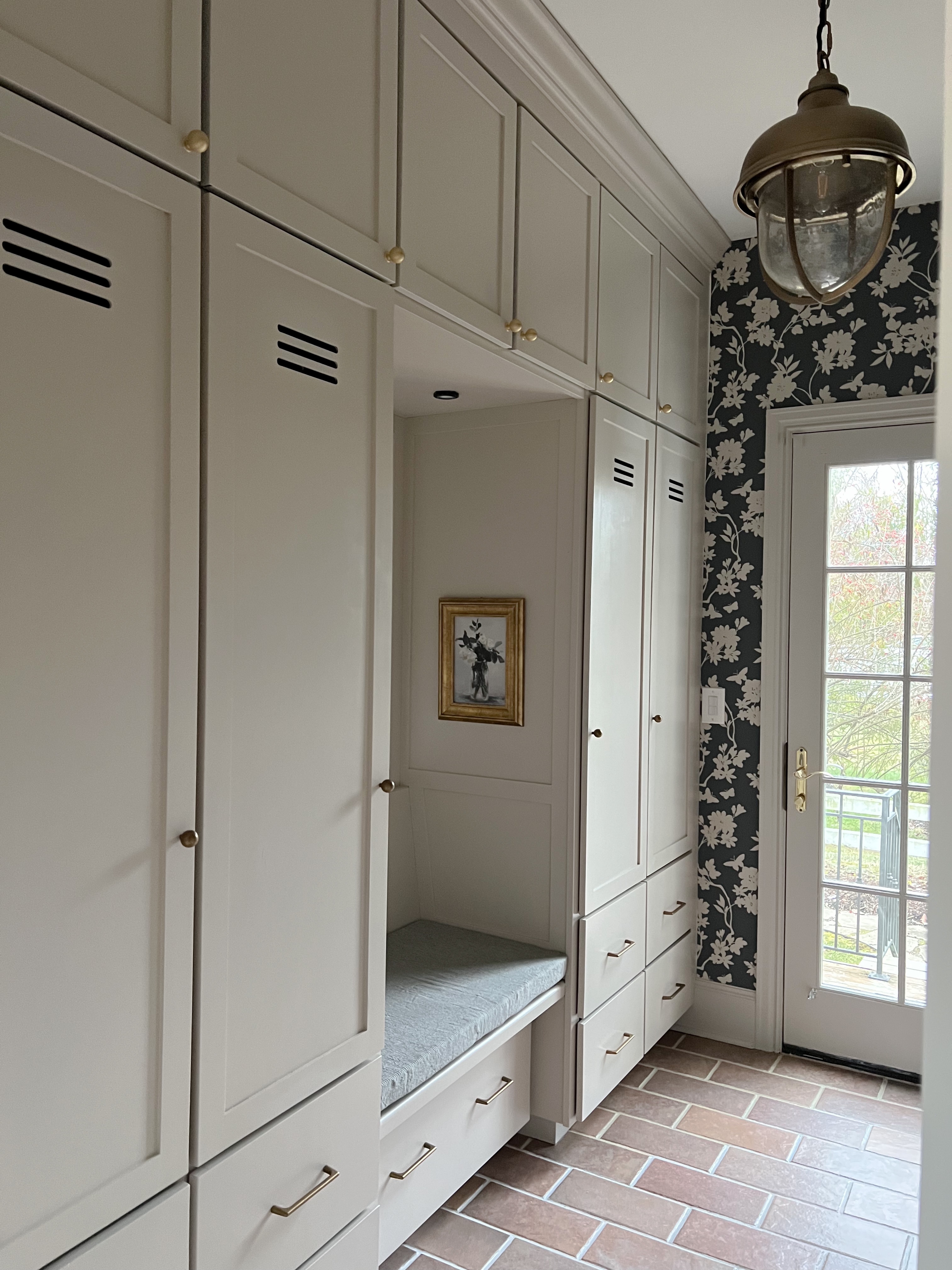 Mudroom Cabinetry with Locker Vents and Floral Wallpaper