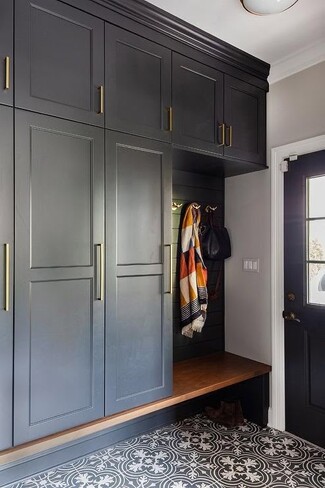 Mudroom Cabinetry with Vertical Brass Hardware and Black